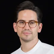 Headshot of Simon Lovell, a white man with dark hair and glasses