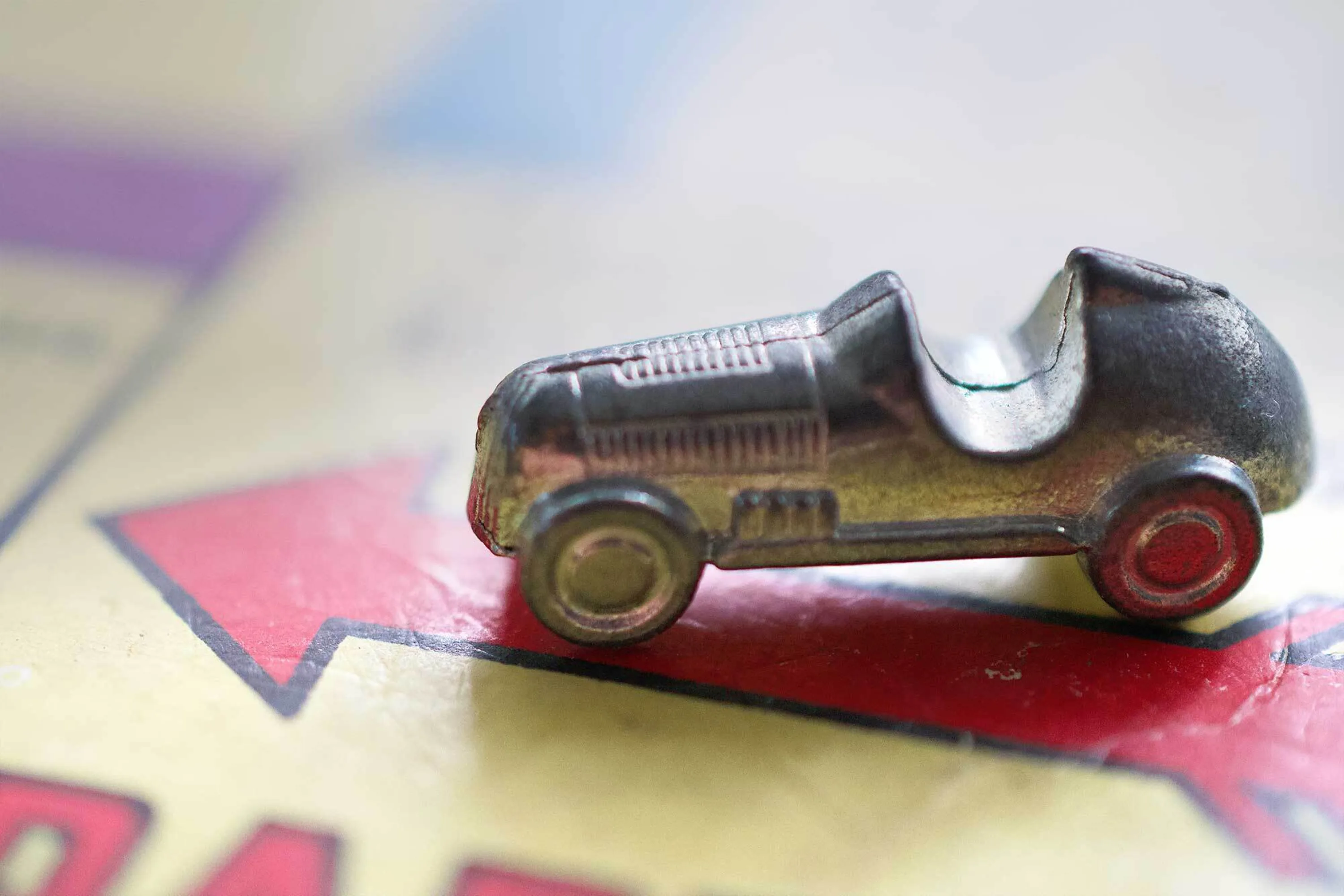 Monopoly car counter on the Pass Go square of the Monopoly board