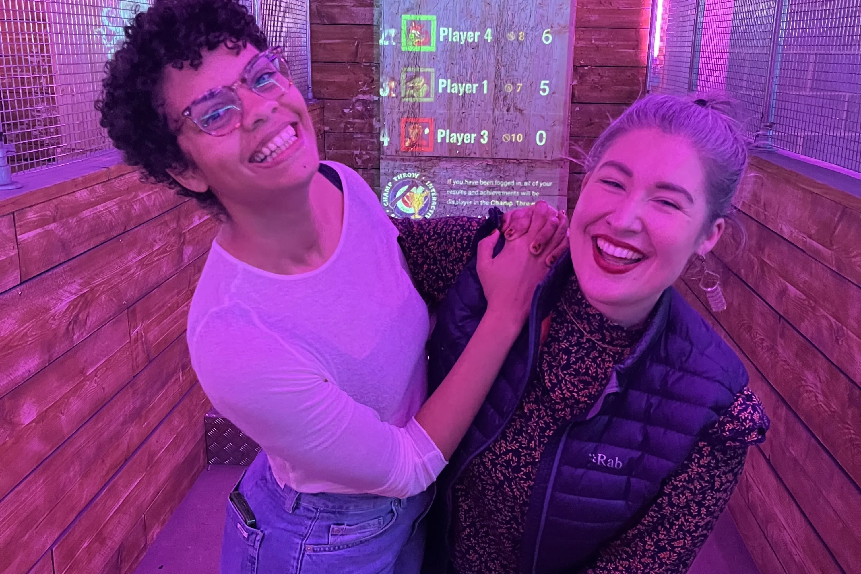 Two women smiling and laughing on a work social