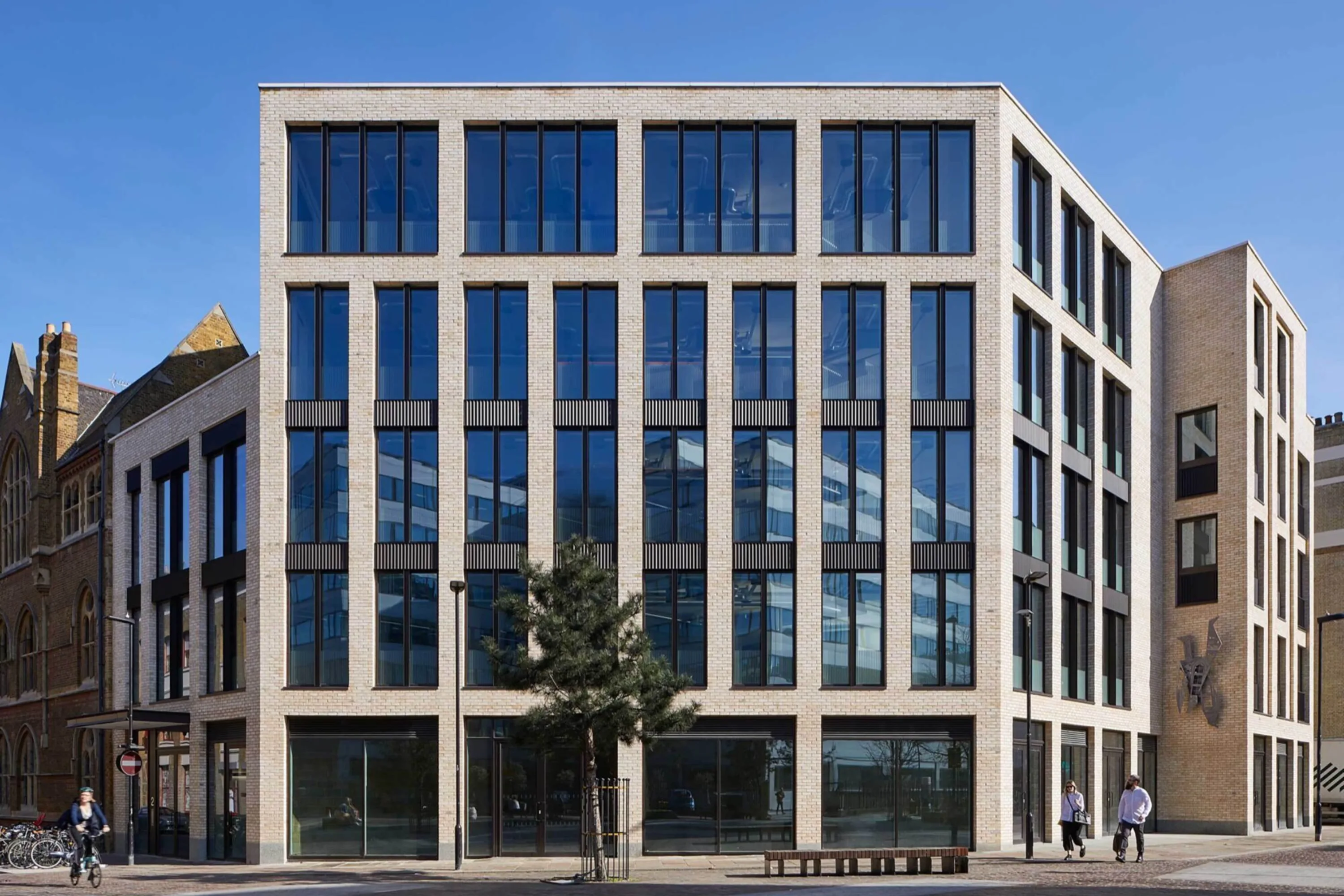 A modern workplace facade with tall windows and 5 stories