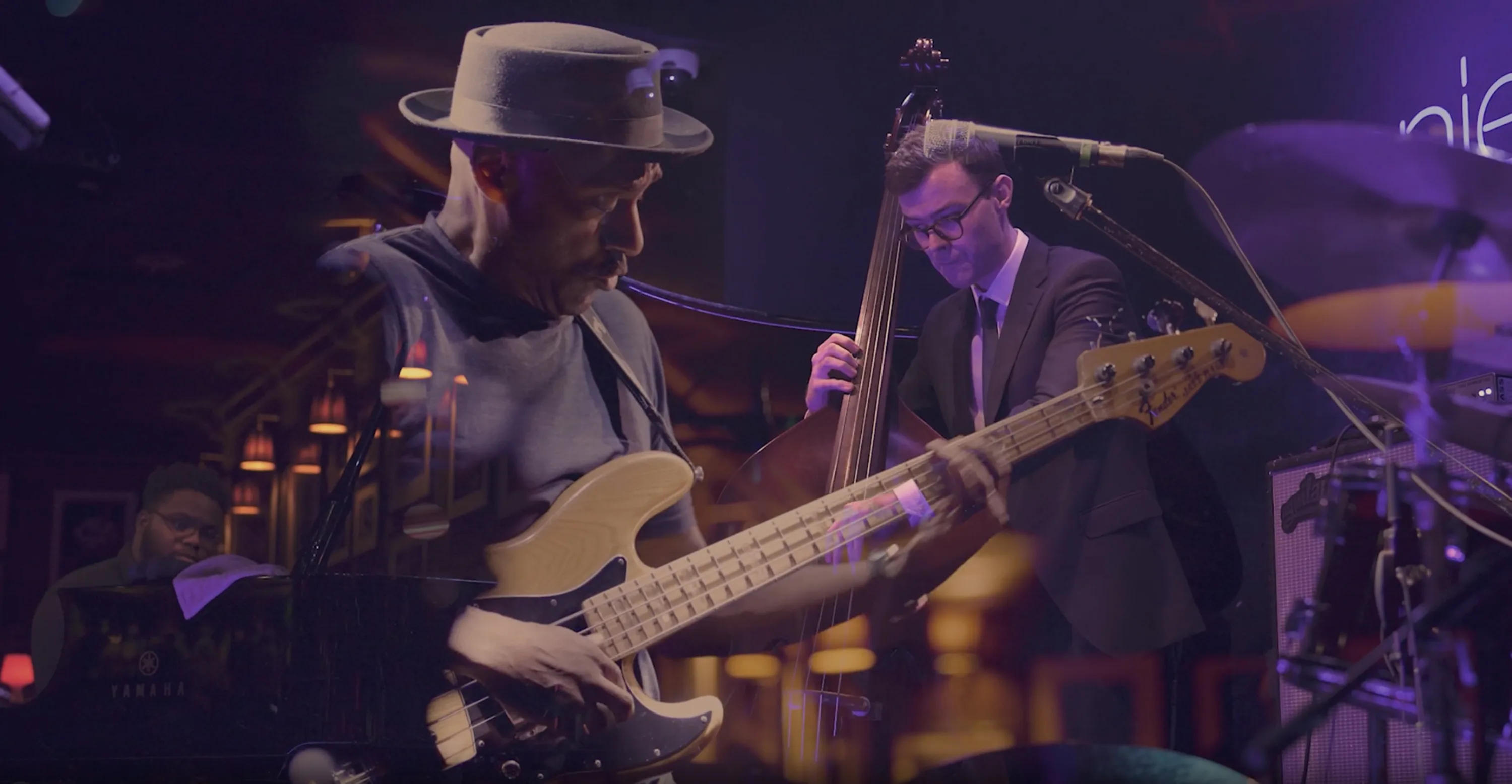 Montage of musicians playing bass guitar, double bass and piano