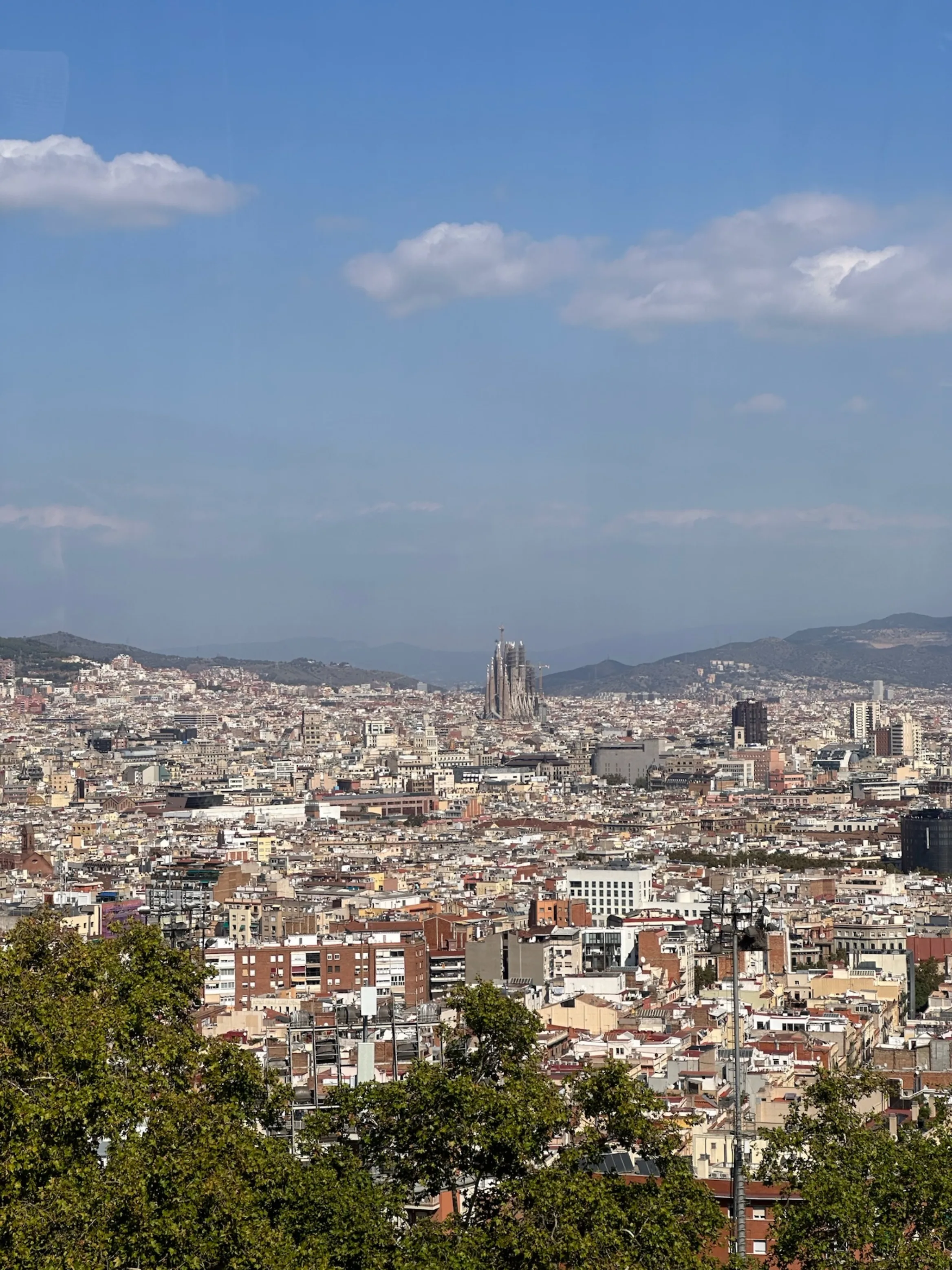 city view of Barcelona from an elevated position with the Sagrada Familia in the distance