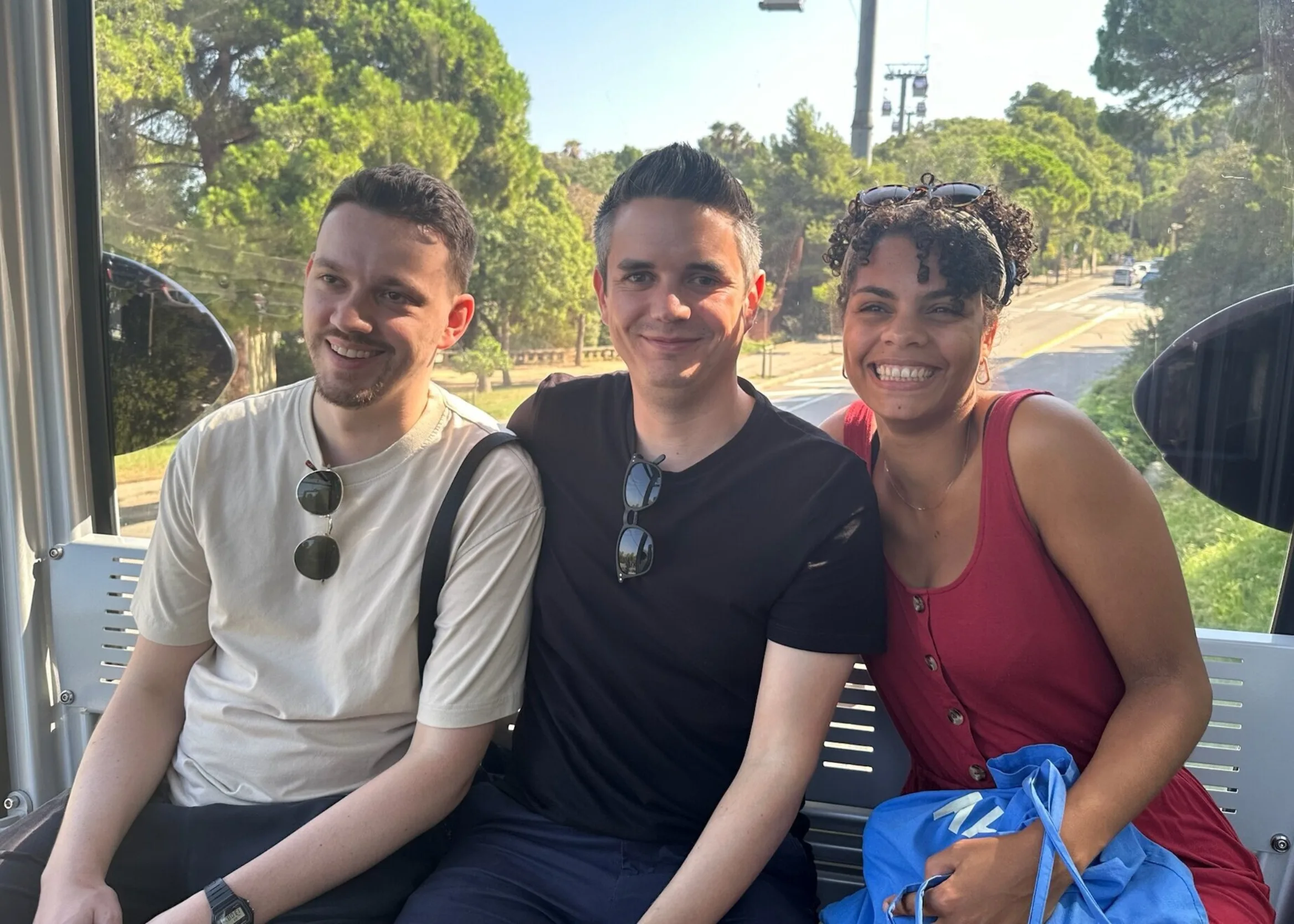 Two men and a woman enjoying a cable car ride