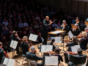 A conductor in front of his orchestra