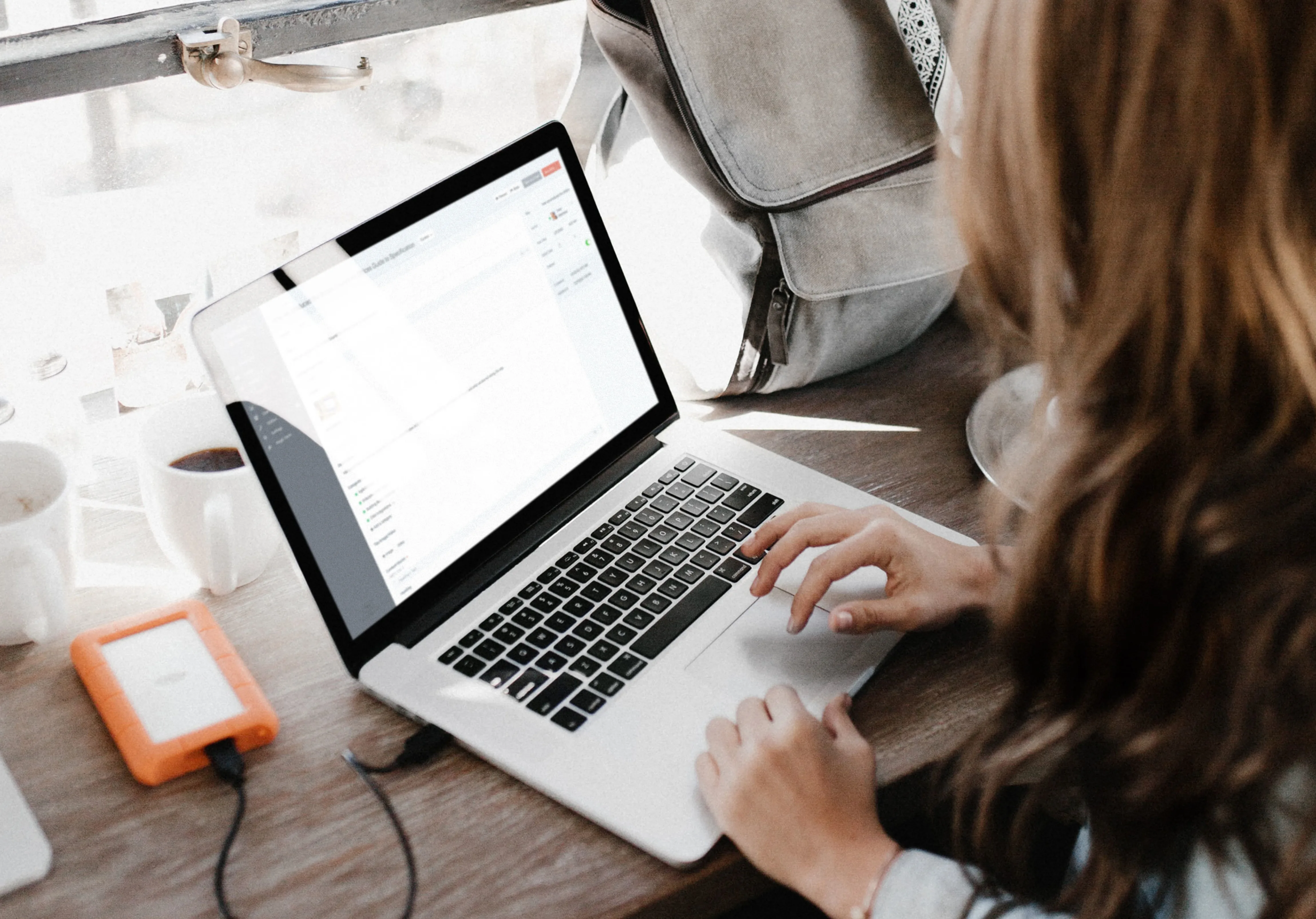 Woman in a cafe editing a website with Craft CMS