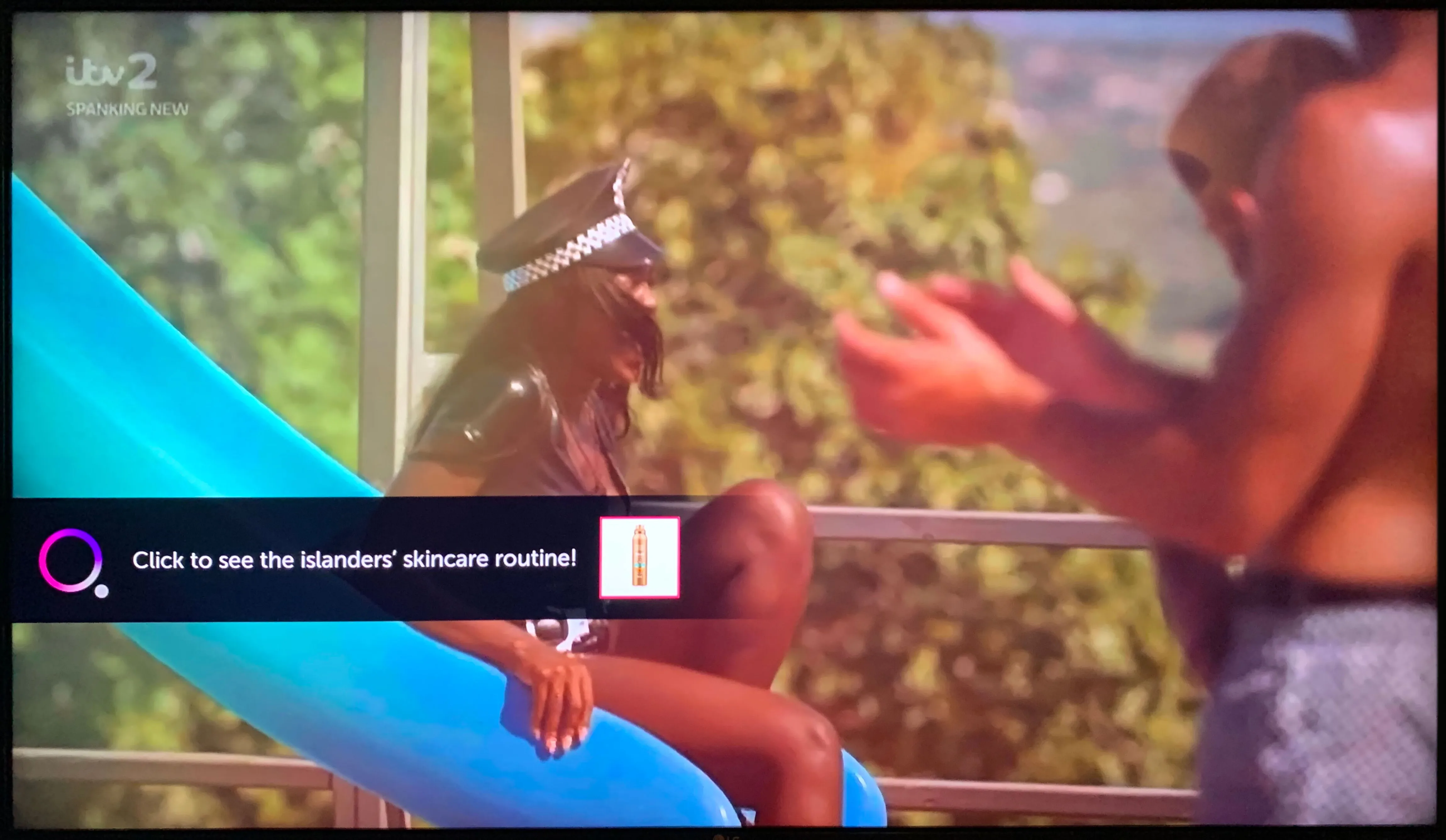 Screenshot of Love Island on with the onscreen message "Click to see the islanders’ skincare routine!