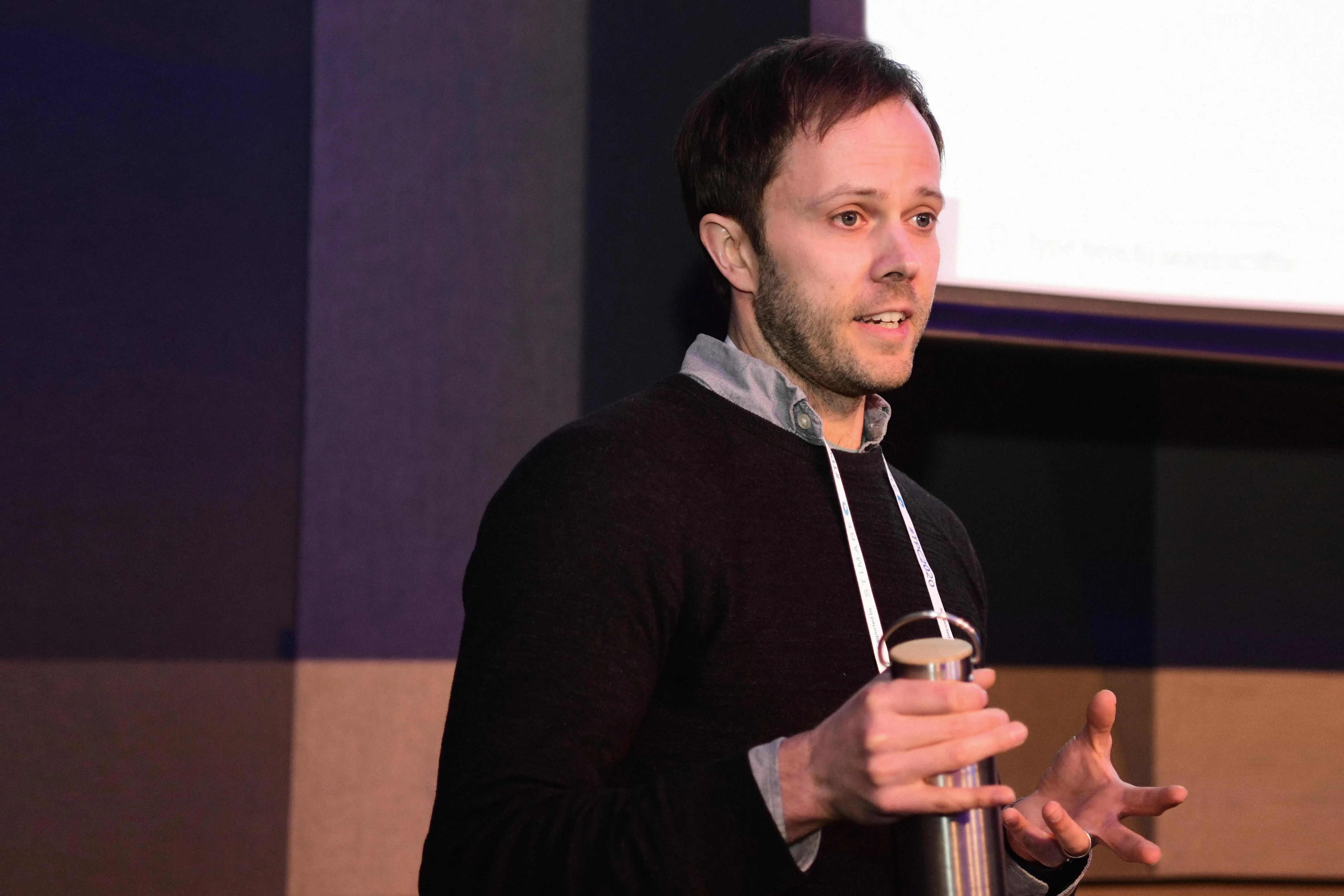 Photograph of Andrew Ladd speaking on stage
